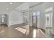Bright living room featuring a front door entrance, hardwood flooring, and large windows with natural light at 5690 Rutland Trce, Lithonia, GA 30058