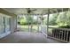 Covered patio with ceiling fan overlooking large fenced backyard at 5690 Rutland Trce, Lithonia, GA 30058
