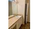 Bathroom vanity featuring large mirror and neutral countertop at 1428 Orchard Park Dr, Stone Mountain, GA 30083