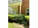 Exterior brick detail with a small, manicured yard and inviting walkout to green space at 1428 Orchard Park Dr, Stone Mountain, GA 30083
