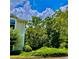 Exterior corner view of a beautiful condo surrounded by lush green trees and landscaping at 1428 Orchard Park Dr, Stone Mountain, GA 30083
