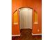 Orange hallway with arched openings and dark hardwood floors at 1428 Orchard Park Dr, Stone Mountain, GA 30083