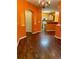 Open-concept living room with hardwood floors, archways, and a view of the kitchen at 1428 Orchard Park Dr, Stone Mountain, GA 30083