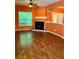 Spacious living room featuring a fireplace, modern ceiling fan, and wood-look flooring at 1428 Orchard Park Dr, Stone Mountain, GA 30083