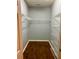 Walk-in closet with built-in wire shelving and hardwood floors at 1428 Orchard Park Dr, Stone Mountain, GA 30083