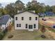View of the backyard showcasing the home's exterior, grassy lawn, and new sliding glass doors at 2312 Herring Sw Rd, Atlanta, GA 30311