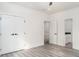 Bedroom with wood-look flooring and large double closet doors, one of two entrances at 2312 Herring Sw Rd, Atlanta, GA 30311