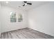 Neutral bedroom with wood-look floors, white walls, and natural light from a pair of windows at 2312 Herring Sw Rd, Atlanta, GA 30311