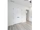 A spacious bedroom with wood-look flooring, white trim, and a set of double doors at 2312 Herring Sw Rd, Atlanta, GA 30311