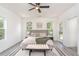 Bright bedroom featuring a ceiling fan, natural light and a doorway leading to the patio at 2312 Herring Sw Rd, Atlanta, GA 30311