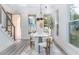 Open dining area featuring modern light fixture and large windows for natural light at 2312 Herring Sw Rd, Atlanta, GA 30311