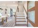 Inviting home entryway with a view of the open-concept living and dining area and modern staircase at 2312 Herring Sw Rd, Atlanta, GA 30311