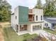 Contemporary home with a two-car carport, balcony, and well-maintained lawn surrounded by trees at 2312 Herring Sw Rd, Atlanta, GA 30311