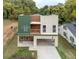 Modern exterior featuring a two-car carport, balcony, and stylish green and neutral-toned siding at 2312 Herring Sw Rd, Atlanta, GA 30311
