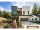 Contemporary home with two-car carport and modern siding next to landscaped yard at 2312 Herring Sw Rd, Atlanta, GA 30311