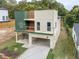 Modern home with open carport and stylish siding nestled on a lot surrounded by lush trees at 2312 Herring Sw Rd, Atlanta, GA 30311