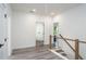 Hallway featuring hardwood floors, recessed lighting, and stairs with modern cable railing at 2312 Herring Sw Rd, Atlanta, GA 30311