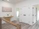 Hallway with wood-look floors, white doors, and decorative table with metallic base at 2312 Herring Sw Rd, Atlanta, GA 30311