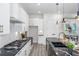 Contemporary kitchen with white cabinets, marble backsplash, and black marbled countertops at 2312 Herring Sw Rd, Atlanta, GA 30311