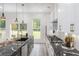Bright, modern kitchen featuring black marble countertops and stainless steel appliances at 2312 Herring Sw Rd, Atlanta, GA 30311