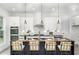 Modern kitchen with a large island, stylish lighting, and stainless steel appliances at 2312 Herring Sw Rd, Atlanta, GA 30311