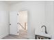 Hallway featuring vinyl floors, a black utility sink and modern finishes at 2312 Herring Sw Rd, Atlanta, GA 30311