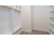 Spacious walk-in closet with custom shelves, drawers and wood-look flooring provides ample storage at 2312 Herring Sw Rd, Atlanta, GA 30311