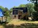 Backyard view of a modern home with a wooden deck and stairs leading down to the lawn at 2625 Semmes St, Atlanta, GA 30344