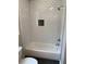 Modern bathroom features a tub with a shower, white subway tile, and a dark tile floor at 2625 Semmes St, Atlanta, GA 30344