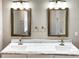 Bathroom featuring double vanity with marble countertop, framed mirrors, and modern lighting at 2625 Semmes St, Atlanta, GA 30344