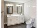 Bathroom featuring double vanity with marble countertop, framed mirrors, and subway tile walls at 2625 Semmes St, Atlanta, GA 30344
