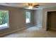A sunlit bedroom featuring neutral walls, plush carpet, and a ceiling fan for added comfort at 2625 Semmes St, Atlanta, GA 30344