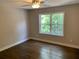 This bedroom boasts hardwood flooring, a bright window, and neutral walls for versatile decor options at 2625 Semmes St, Atlanta, GA 30344