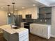 Bright kitchen with a marble island, stainless steel appliances, and modern fixtures at 2625 Semmes St, Atlanta, GA 30344