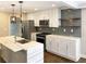 Modern kitchen features stainless steel appliances, white cabinets, and a marble countertop island at 2625 Semmes St, Atlanta, GA 30344