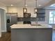 Bright kitchen with a marble island, stainless steel appliances, and modern lighting at 2625 Semmes St, Atlanta, GA 30344