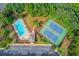 Aerial view of the community pool and tennis courts, surrounded by trees and landscaping at 4092 Duran Ln, Auburn, GA 30011