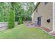 Picturesque backyard featuring lush lawn, patio seating, privacy fence, and shade trees offering a serene escape at 4092 Duran Ln, Auburn, GA 30011