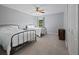 Neutral-toned bedroom with carpet, a ceiling fan, a window, and two matching beds provides comfortable accommodation at 4092 Duran Ln, Auburn, GA 30011