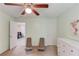 Bedroom with soft walls, carpet, natural light, a ceiling fan, and lounge chairs provides access to other rooms at 4092 Duran Ln, Auburn, GA 30011