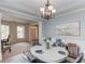 Charming dining room featuring wainscoting, modern lighting, and seamless access to other living spaces at 4092 Duran Ln, Auburn, GA 30011