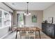 Dining room with natural light, a modern chandelier, and neutral decor at 4092 Duran Ln, Auburn, GA 30011