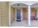 A welcoming front porch with a black door, complemented by brick accents and comfortable seating at 4092 Duran Ln, Auburn, GA 30011