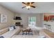 Inviting living room boasts a fireplace, ceiling fan, and access to the backyard at 4092 Duran Ln, Auburn, GA 30011