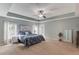 Generous main bedroom with tray ceilings, ceiling fan, and large windows at 4092 Duran Ln, Auburn, GA 30011