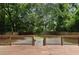 View of the backyard featuring a wooden deck, privacy fence, and a fire pit at 1218 Crestwood Se Dr, Atlanta, GA 30316