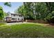 Spacious backyard with a deck, lawn, privacy fence, and mature trees at 1218 Crestwood Se Dr, Atlanta, GA 30316