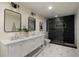 Modern bathroom featuring dual sinks, graphic tile floors, and a sleek, glass-enclosed shower at 1218 Crestwood Se Dr, Atlanta, GA 30316