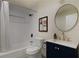 Modern bathroom featuring subway tile, a shower-tub combo, and a vanity with a round mirror at 1218 Crestwood Se Dr, Atlanta, GA 30316