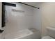 Modern bathroom featuring white subway tile, a shower-tub combo, and a convenient corner bench at 1218 Crestwood Se Dr, Atlanta, GA 30316